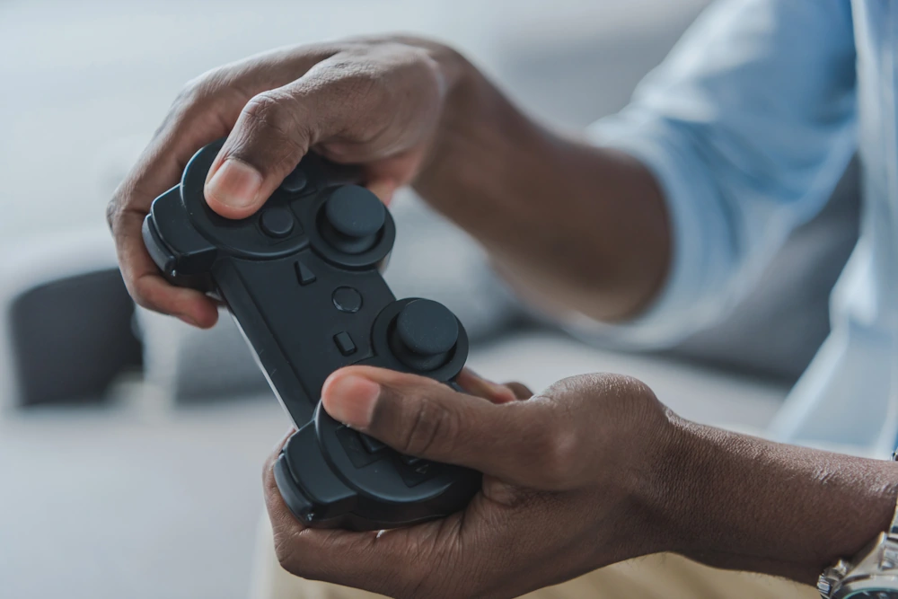 Hands holding a joystick while esporting