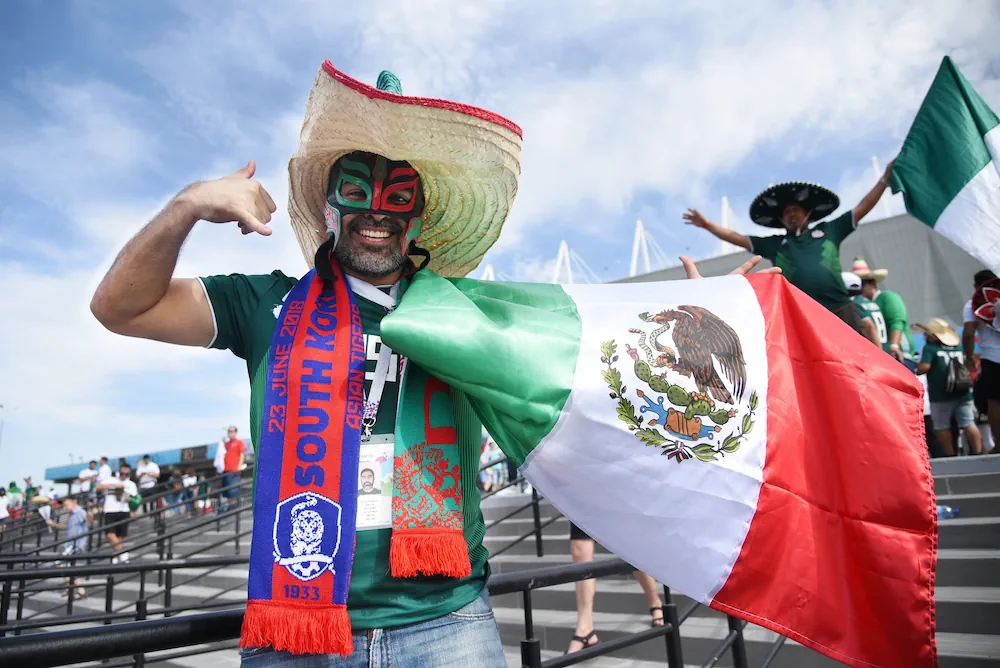 Mexican fan holding a Mexican flag