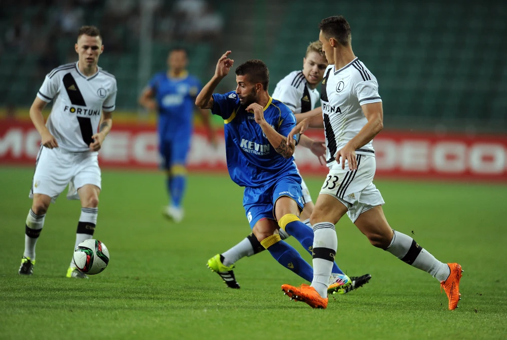 Football players in action in match