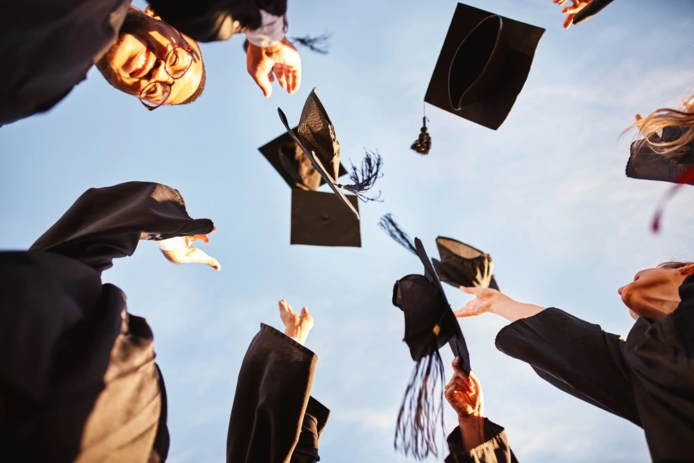 Students graduating throwing hats